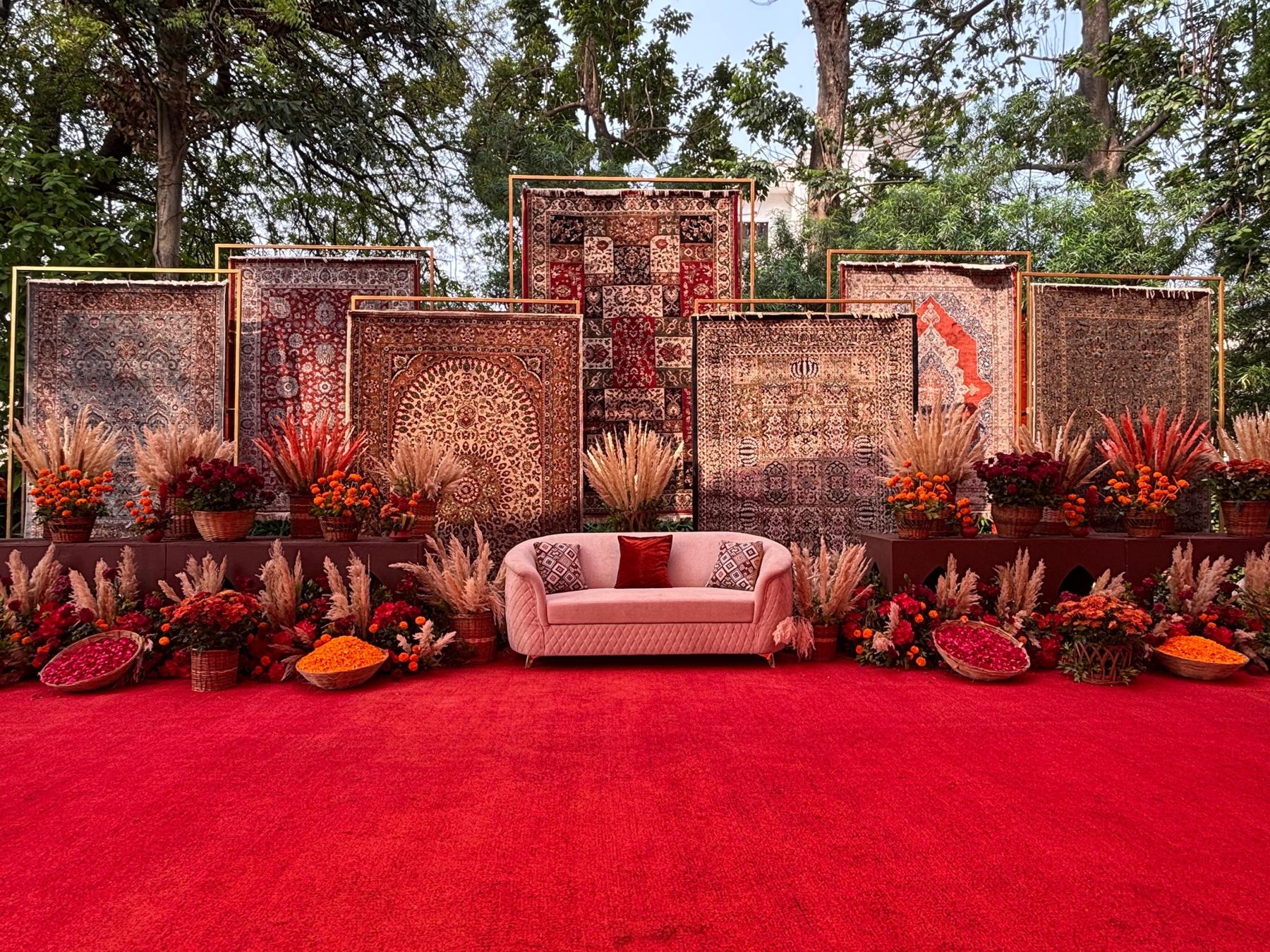 Stage of framed heritage carpets with pampas and marigolds